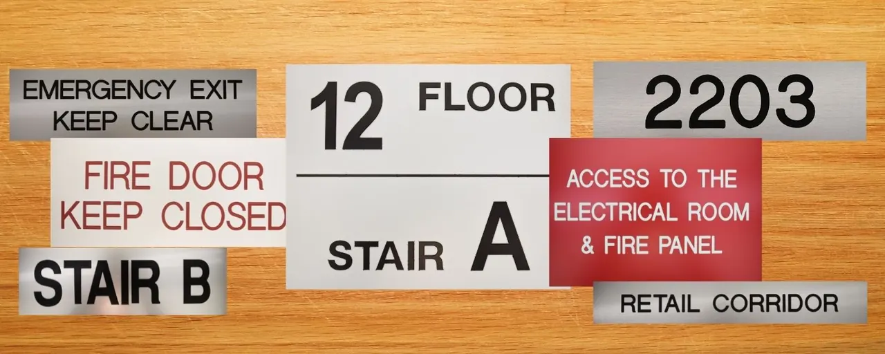 Assortment of custom engraved signs in brushed aluminium, red and white